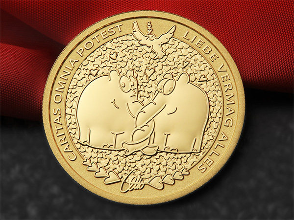 1oz Goldmünze mit zwei verliebten Ottifanten vor einem Herzchenteppich 