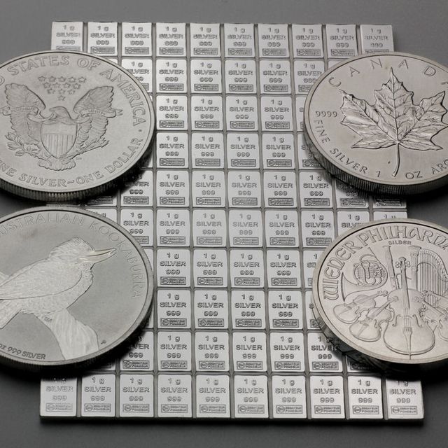 100g Silbertafel neben 1oz Silbermünzen