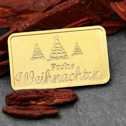 Motivgravur "Frohe Weihnachten" auf 2,5g Gold